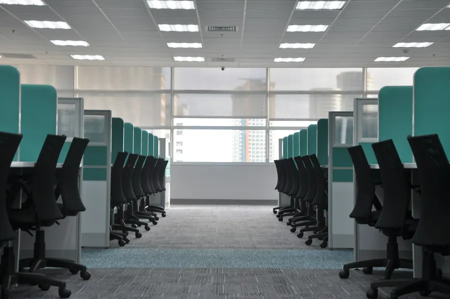 Rows of clean, tidy desks and chairs in a bright office